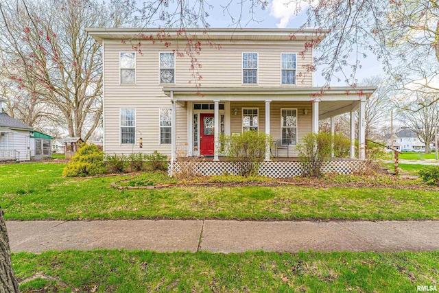 italianate house featuring a front yard and covered porch