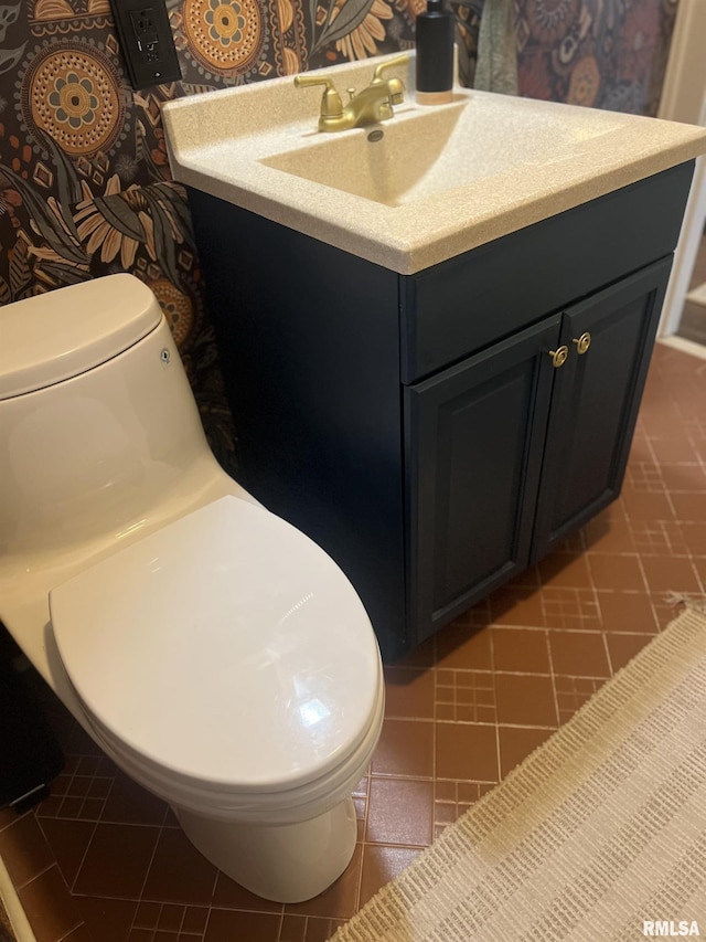 1037 Brown Ave, Galesburg, IL 61401 - half bathroom featuring toilet, vanity, and tile patterned flooring