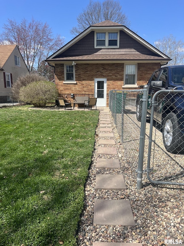 1037 Brown Ave, Galesburg, IL 61401 - view of front of home with a front yard, brick siding, and fence