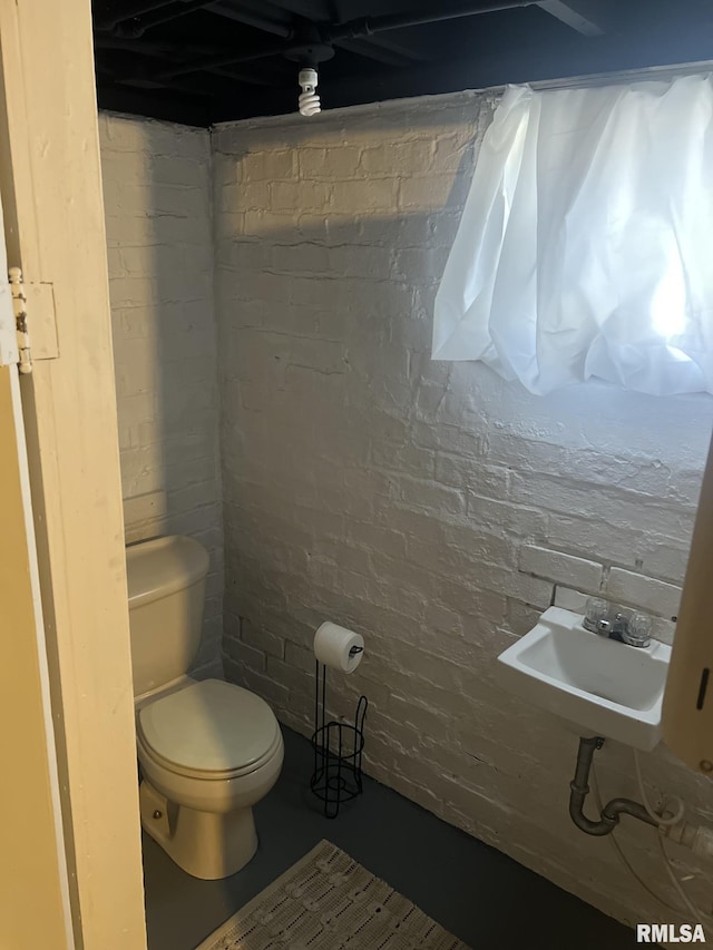 1037 Brown Ave, Galesburg, IL 61401 - bathroom with toilet, brick wall, and a sink