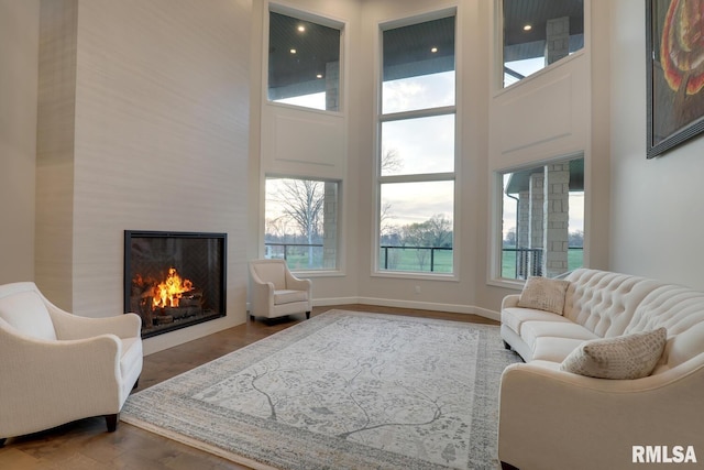 2300 Greenspointe Cir, Quincy, IL 62301 - living area with a towering ceiling, a warm lit fireplace, and wood finished floors