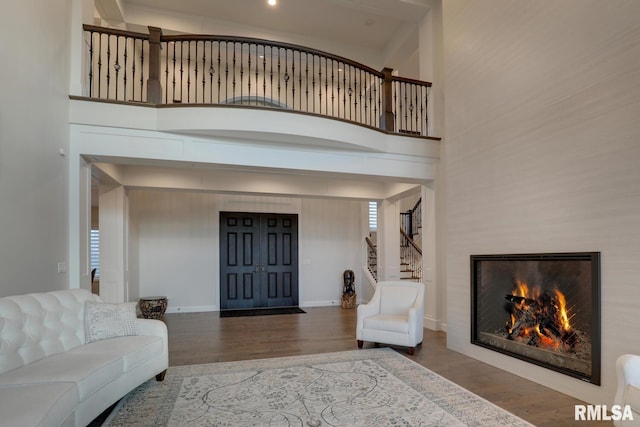 2300 Greenspointe Cir, Quincy, IL 62301 - living area featuring wood finished floors, a warm lit fireplace, and stairs