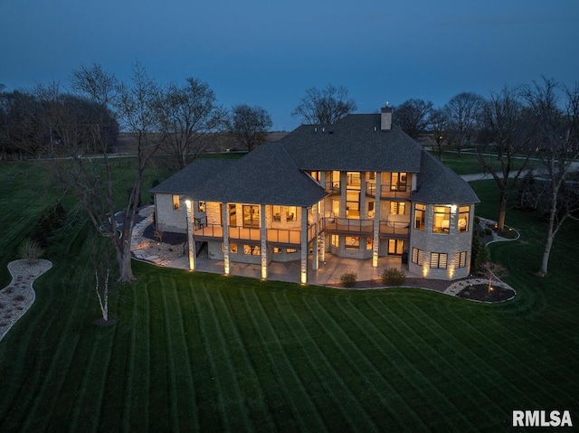 2300 Greenspointe Cir, Quincy, IL 62301 - rear view of property with a yard, a patio area, a shingled roof, and a chimney