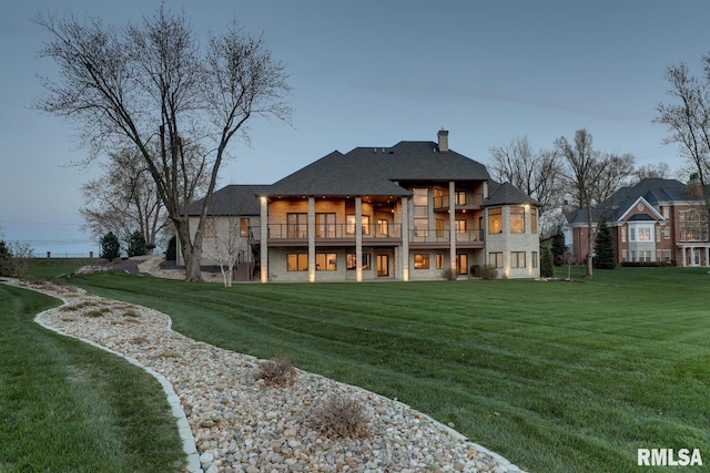 2300 Greenspointe Cir, Quincy, IL 62301 - rear view of house with a yard, stone siding, roof with shingles, and a chimney