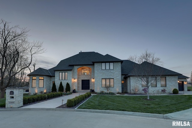 2300 Greenspointe Cir, Quincy, IL 62301 - french country home featuring stone siding, a lawn, and roof with shingles