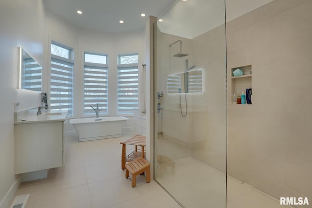 2300 Greenspointe Cir, Quincy, IL 62301 - bathroom featuring walk in shower, a freestanding tub, vanity, tile patterned floors, and recessed lighting