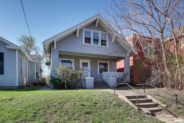304 Chestnut St, Quincy, IL 62301 - view of front facade with a porch, stucco siding, and a front lawn