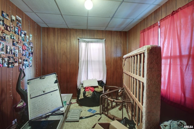 304 Chestnut St, Quincy, IL 62301 - bedroom with wood walls, a paneled ceiling, and carpet flooring