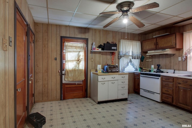304 Chestnut St, Quincy, IL 62301 - kitchen with light countertops, ceiling fan, under cabinet range hood, white range with gas cooktop, and light floors