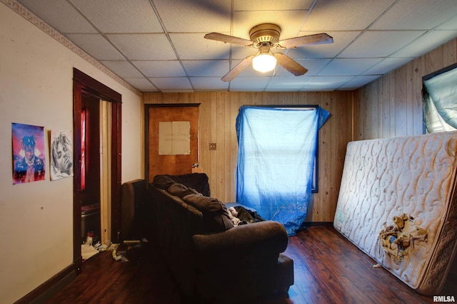 304 Chestnut St, Quincy, IL 62301 - living room with wooden walls, a ceiling fan, a paneled ceiling, and wood finished floors