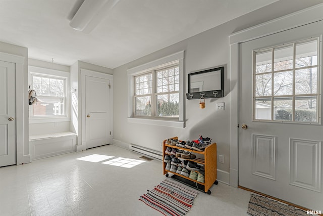 doorway with a baseboard heating unit and baseboards