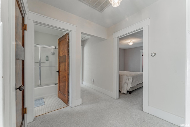 corridor with visible vents, baseboards, and carpet