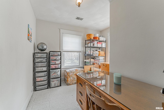 office featuring light colored carpet, baseboards, and visible vents