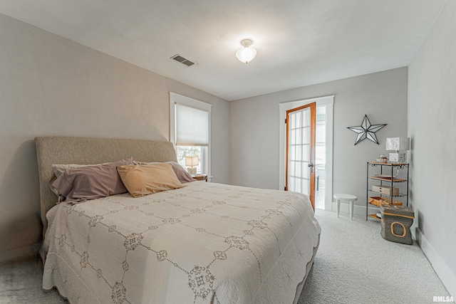 carpeted bedroom with visible vents and baseboards