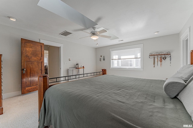 bedroom with baseboards, visible vents, light colored carpet, and a ceiling fan