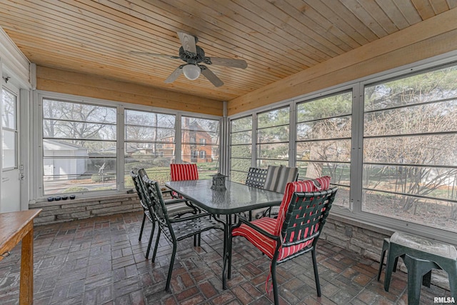 sunroom featuring ceiling fan and outdoor dining area