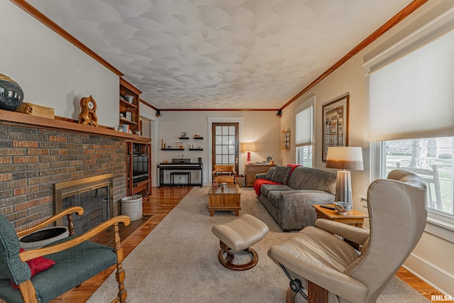living room with a fireplace, baseboards, crown molding, and wood finished floors