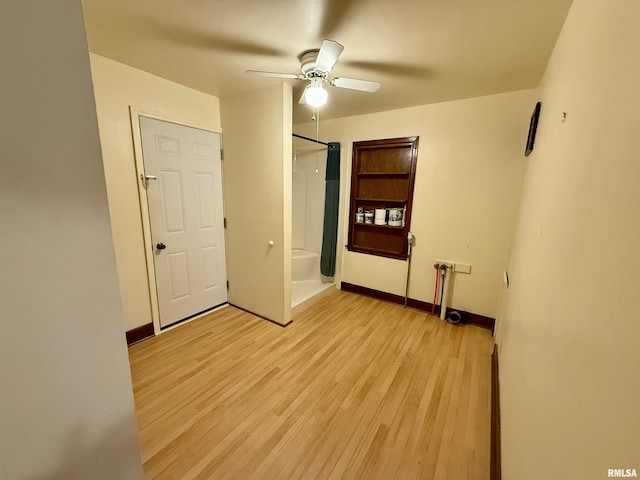 424 Lashmett Ct, Rushville, IL 62681 - unfurnished bedroom featuring light wood finished floors, baseboards, and ceiling fan