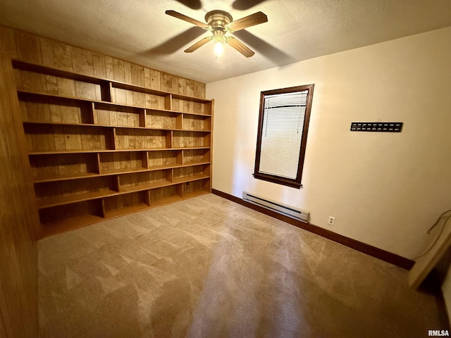 424 Lashmett Ct, Rushville, IL 62681 - unfurnished room with baseboard heating, ceiling fan, carpet, a textured ceiling, and baseboards