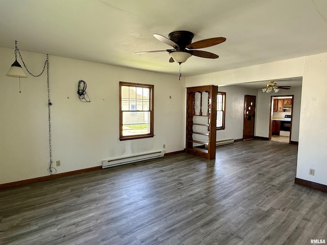 424 Lashmett Ct, Rushville, IL 62681 - unfurnished living room featuring baseboard heating, ceiling fan, baseboards, and dark wood-type flooring