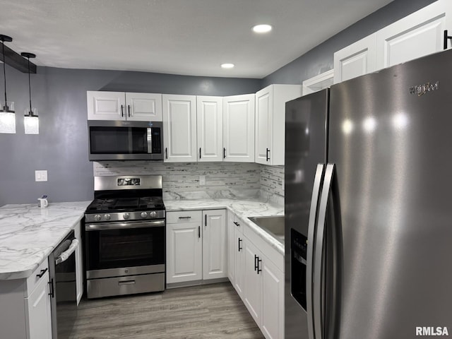 kitchen featuring white cabinetry, tasteful backsplash, and appliances with stainless steel finishes