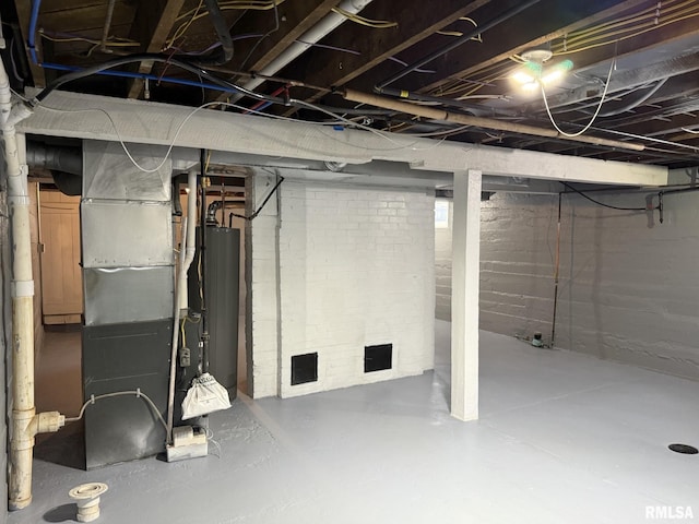 unfinished basement with gas water heater and heating unit