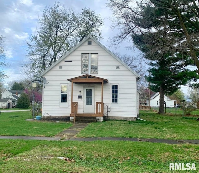 bungalow-style house with a front lawn and fence