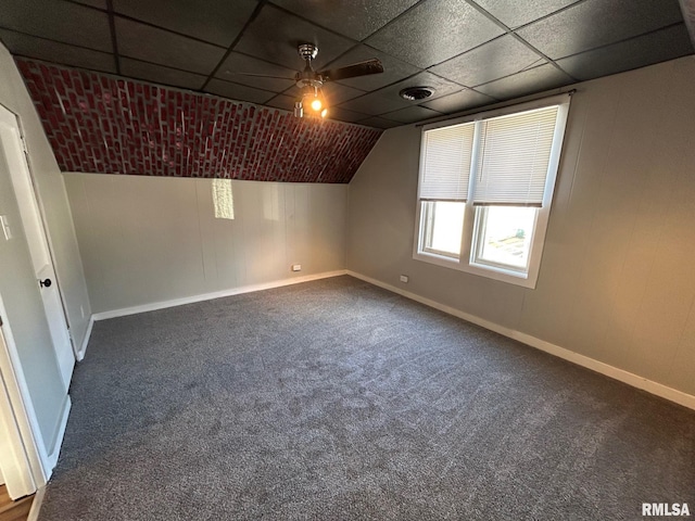 bonus room featuring baseboards, dark colored carpet, and lofted ceiling