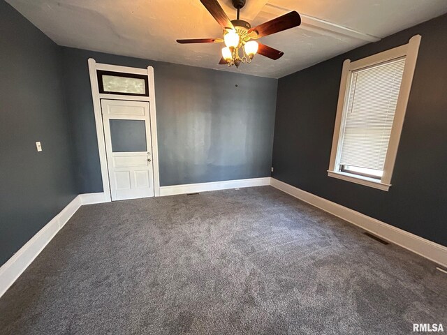 spare room with ceiling fan, baseboards, and carpet floors