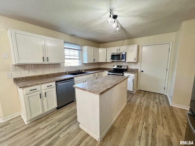 905 W Wind Rose Ln, Athens, IL 62613 - kitchen with a sink, backsplash, appliances with stainless steel finishes, and light wood finished floors