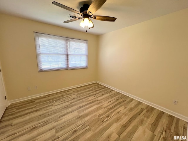905 W Wind Rose Ln, Athens, IL 62613 - unfurnished room with wood finished floors, baseboards, and a ceiling fan