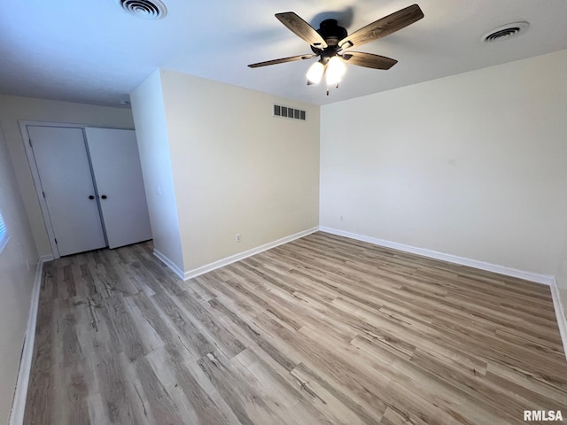 905 W Wind Rose Ln, Athens, IL 62613 - unfurnished bedroom with visible vents, baseboards, and wood finished floors