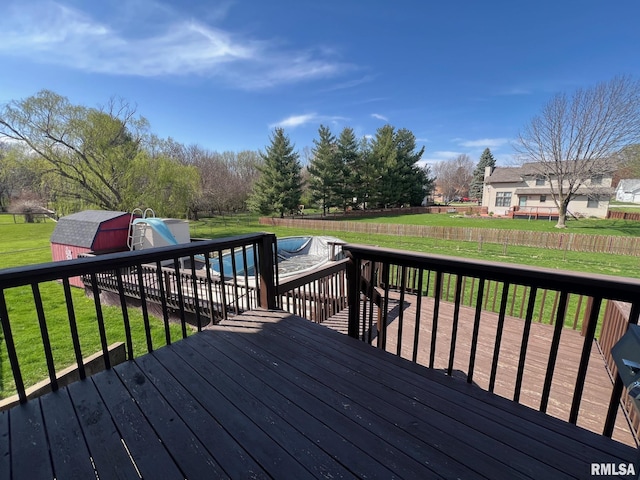 905 W Wind Rose Ln, Athens, IL 62613 - deck featuring a storage unit, a fenced backyard, an outdoor structure, and a lawn
