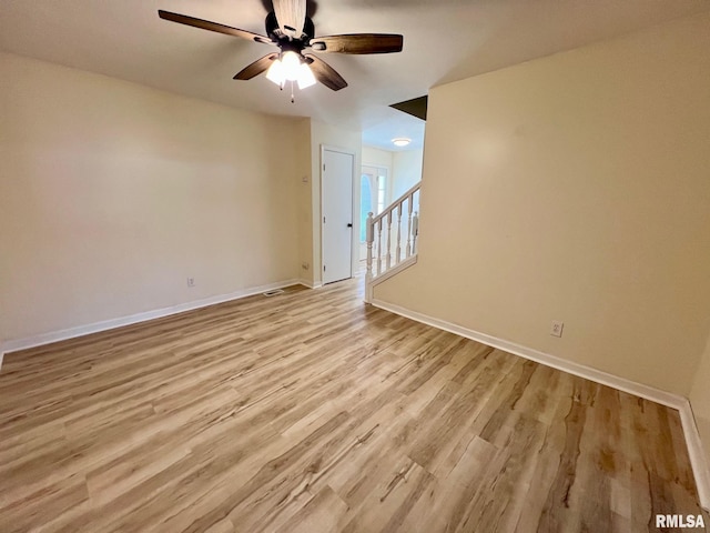 905 W Wind Rose Ln, Athens, IL 62613 - empty room with light wood-style floors, baseboards, and a ceiling fan