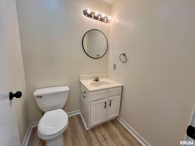 905 W Wind Rose Ln, Athens, IL 62613 - bathroom with vanity, baseboards, toilet, and wood finished floors
