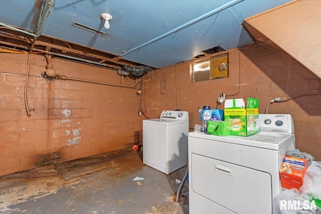 clothes washing area featuring washing machine and dryer and laundry area