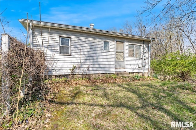 rear view of property featuring a yard