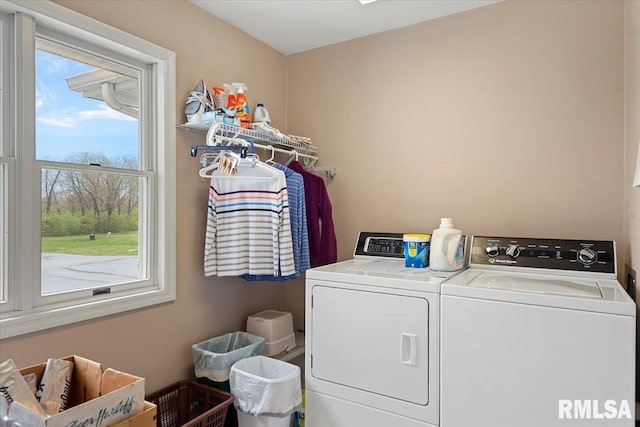 washroom with independent washer and dryer and laundry area