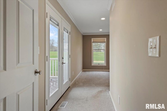 hallway featuring visible vents, baseboards, crown molding, recessed lighting, and carpet flooring