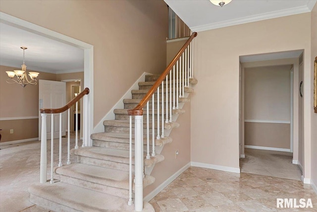 stairs with ornamental molding, baseboards, and a notable chandelier