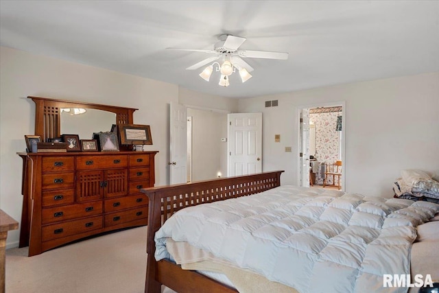bedroom with light carpet, a ceiling fan, and visible vents