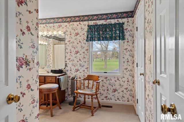bathroom featuring baseboards, vanity, and wallpapered walls