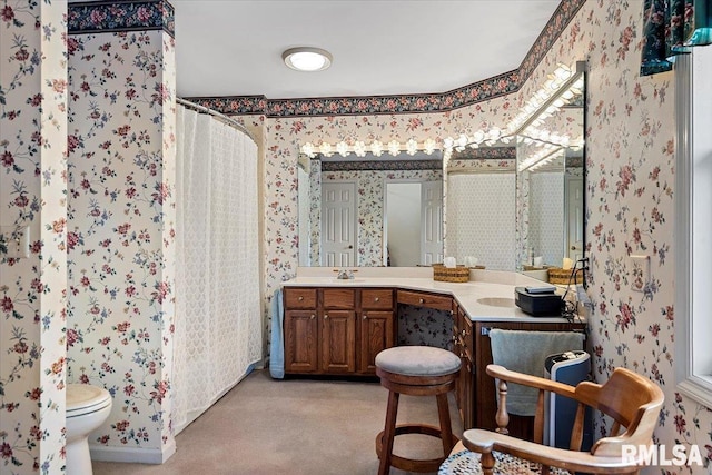 bathroom with toilet, wallpapered walls, vanity, and a shower with curtain