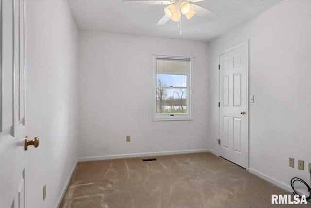 unfurnished bedroom with carpet flooring, visible vents, baseboards, and a ceiling fan