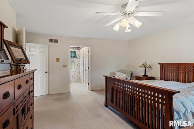 bedroom featuring visible vents, baseboards, ceiling fan, and light colored carpet