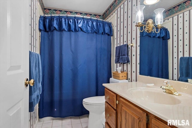 bathroom featuring toilet, vanity, tile patterned flooring, and a shower with curtain