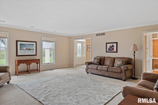living room featuring light carpet, baseboards, ornamental molding, and visible vents