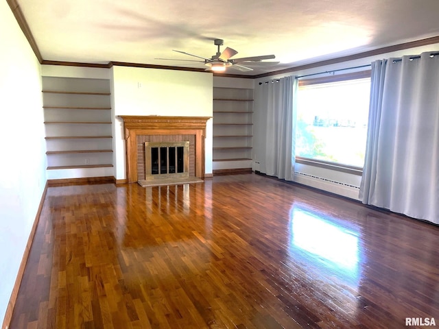 unfurnished living room with a ceiling fan, dark wood finished floors, ornamental molding, and built in shelves