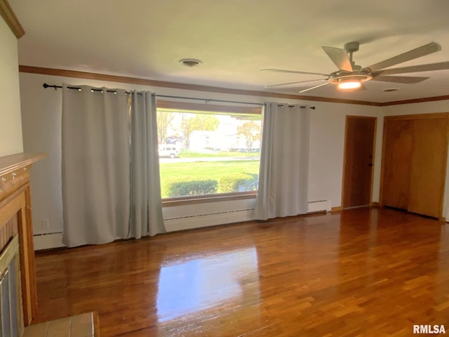 unfurnished living room featuring light wood-style floors, ornamental molding, a ceiling fan, visible vents, and a tiled fireplace