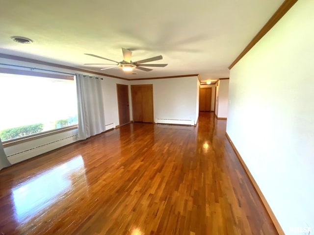 unfurnished room with crown molding, a ceiling fan, visible vents, baseboard heating, and dark wood-style flooring